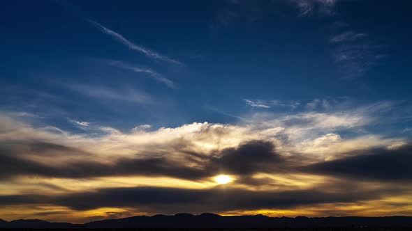 The glowing sun sets beyond the distant Mojave Desert Mountains in this forward and reverse infinite