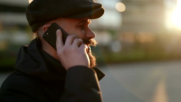 Serious Man is Communicating By Mobile Phone Outdoors in City Street Portrait Shot