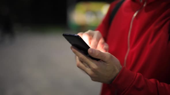 Unrecognizable Person with Smartphone in the Park