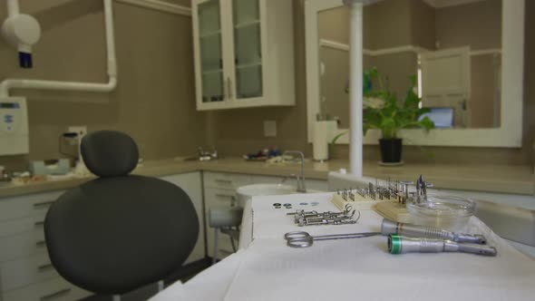 Empty interior of dental clinic with black dental chair and tools