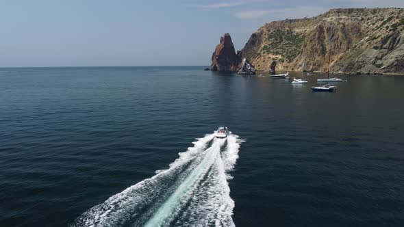 Happy People are Going to Swim on an Air Mattress Behind a Jet Ski