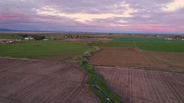 Aerial view flying over farmland in Idaho during sunset
