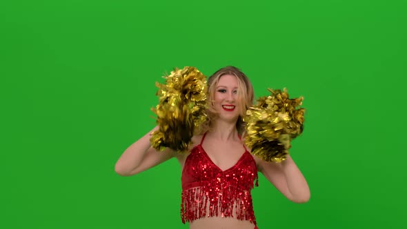 A Cheering Dance Performed By a Pretty Cheerleader with Pompoms in Her Hands in the Studio on a