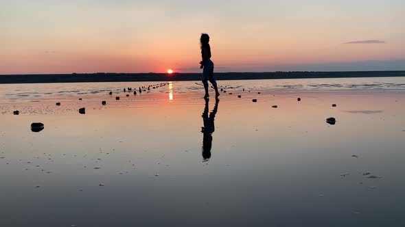 Free happy woman dancing and enjoying the sunset view.