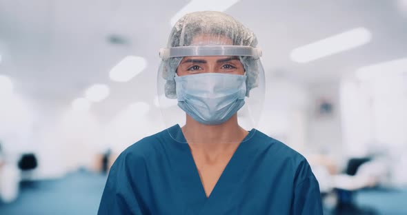 Portrait of Young Doctor Female in Protective Gear and Medical Mask, Woman Looks at the Camera and