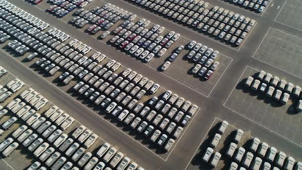 Faraway aerial view of group of cars at parking space on a desert landscape.