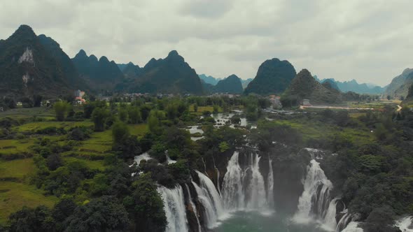 Boats floating near waterfall