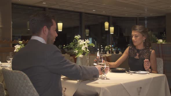 A man and woman couple dining in a luxury restaurant