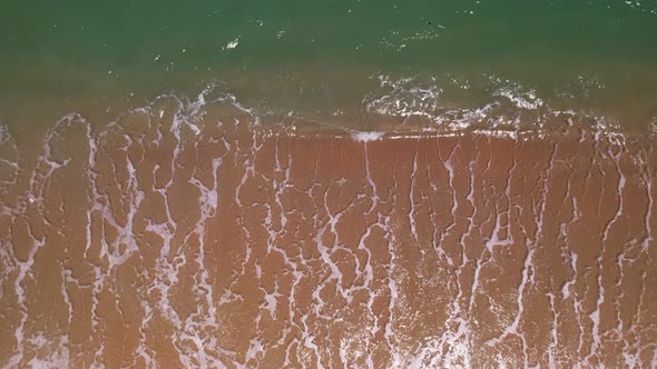 Beautiful texture of big waves power ocean waves with white waves break on beach sand at Phuket