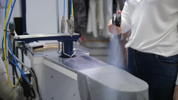 Female Hands Steaming Clothes During Cleaning