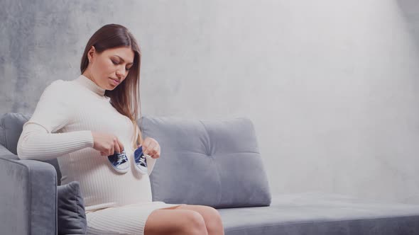 Young pregnant woman is resting at home and expecting a baby.