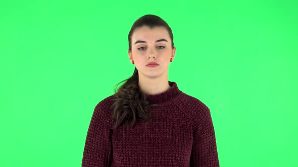 Tired Girl Falls Asleep While Standing, Awake and Looks at the Camera. Green Screen