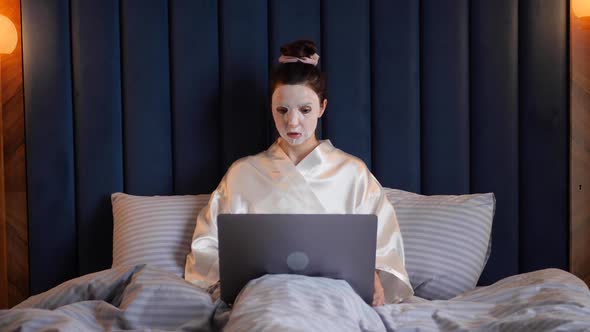 Young Woman Applies Cleansing Mask on Her Face