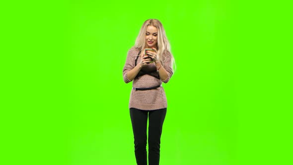 Girl Blonde Goes and Look at Your Phone. Green Screen