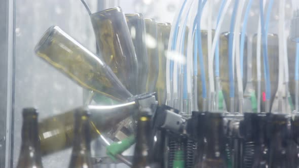 Red Wine bottles on a conveyor belt in a wine bottling factory.