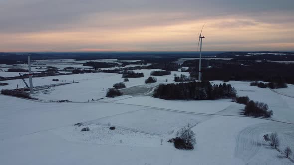 Aerial view of a wind farm in winter. Aerial view of rotating wind turbines.