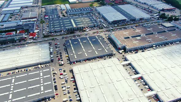 Aerial footage of a large shopping centre and car parks located in the city