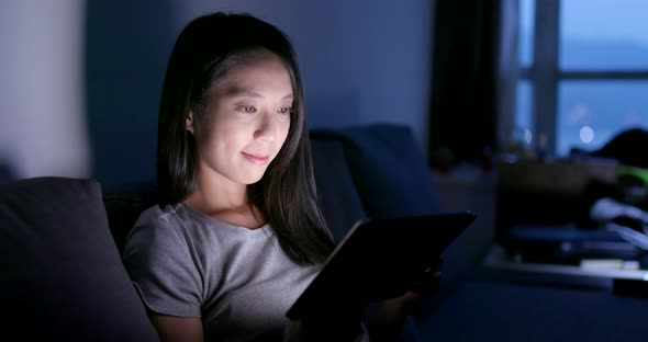 Woman work on tablet computer in the evening