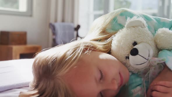 Girl sleeping with her teddy bear