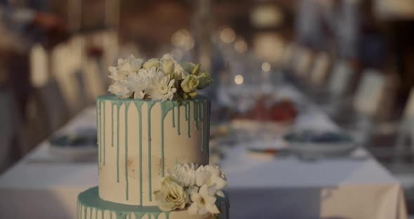 Large festive wedding white cake on a background of a table with snacks