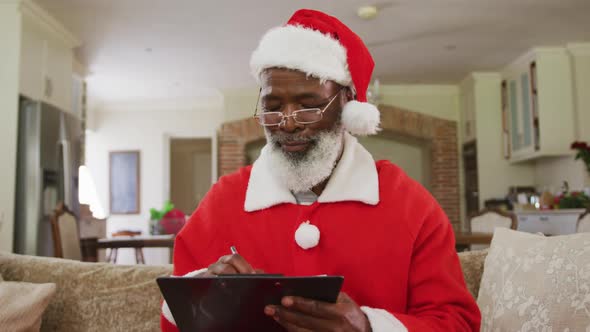 Senior african american man wearing santa costume at christmas time