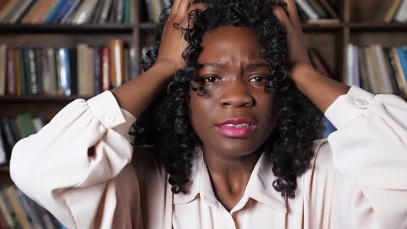 Stressed Afroamerican Businesswoman Raises Hands in Despair
