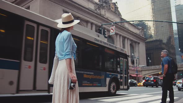 Attractive girl with a retro camera at the Grand Central Terminal