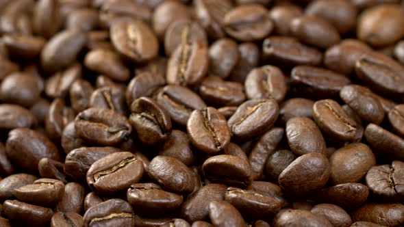 Coffee Beans Background. Close Up Shot of Rotating Roasted Coffee Beans