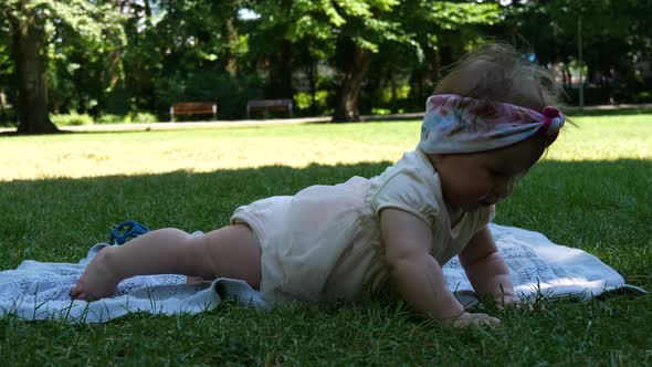 Little baby lying on the grass in the park