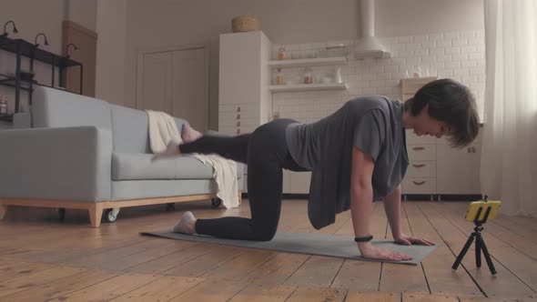 Young Woman Starts her Online Fitness Training