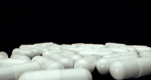 White healthy diet suplement medicine pills  fly over super macro close up