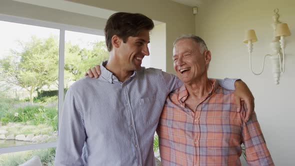 Caucasian father and son smiling at camera