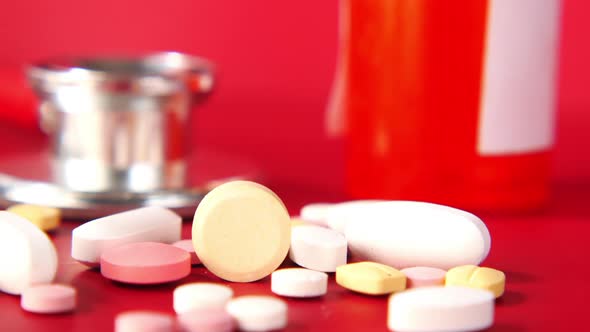 Close Up of Many Colorful Pills and Capsules on Red Background