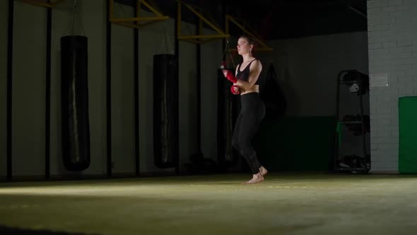 Concentration Kickboxing and Coordination Training Young Female Fighter Jumps on a Rope Strength Fit