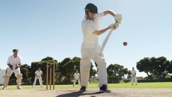 Batsman playing a defensive stroke during cricket match