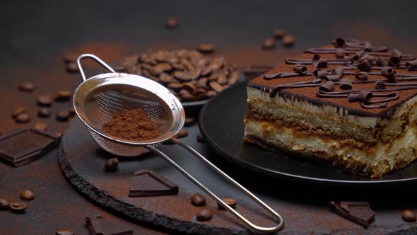 Portion of Traditional Italian Tiramisu dessert and coffee beans