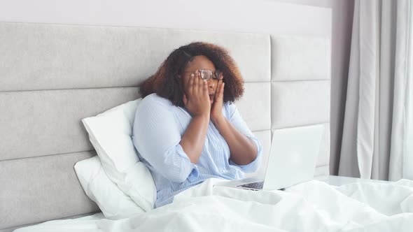 Young Afro Woman Falls Asleep From a Long Work at Laptop