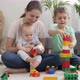 Smiling Happy Family Building High Tower with Toy Blocks and Bricks - VideoHive Item for Sale