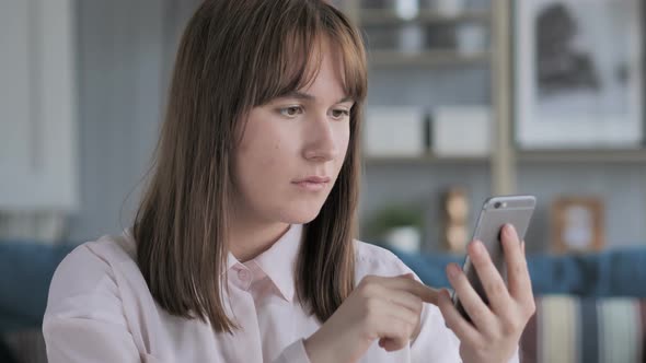 Young Girl Browsing Internet on Smartphone, Using Applications