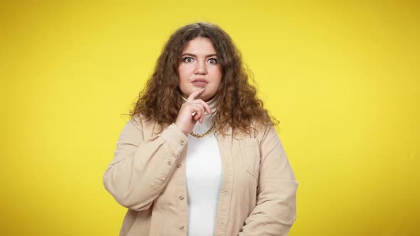 Plussize Caucasian Brunette Curlyhaired Woman Showing I Got an Idea Gesture Smiling Looking at