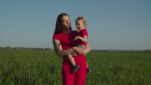 Mother with Little Daughter Relaxing in Nature