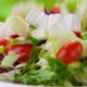 Fresh salad falling into bowl on green background - VideoHive Item for Sale