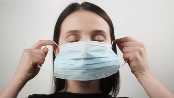 Pandemic Portrait of a Young European Smiling Woman Wearing Protective Mask on Home Isolation