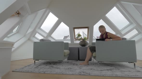 Woman with Pad in the Room of Cube House