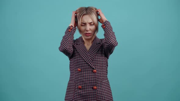 The Stressed Young Woman Puts Her Hands on Her Head Tired Prays for a Break Exhausted and Looks