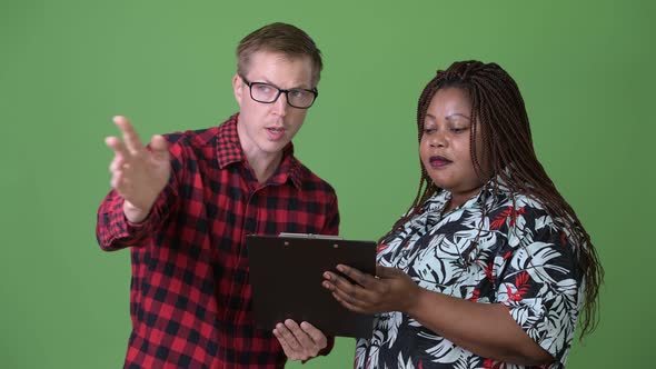 Overweight African Woman and Young Scandinavian Man Together Against Green Background