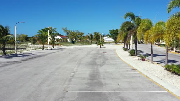 Entrance Barrier Gate To Parking Lot at Caribbean City with Coconut Palm Trees