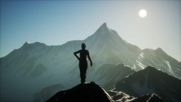 Woman Standing In Snow Wearing Warm Clothes In Mountains