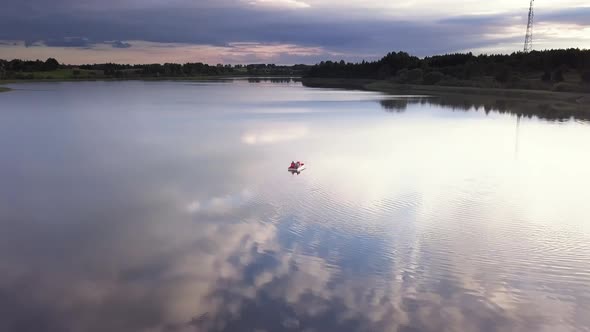 Family on a Pedal Boat on a Lake at Sunset Drone Shot.