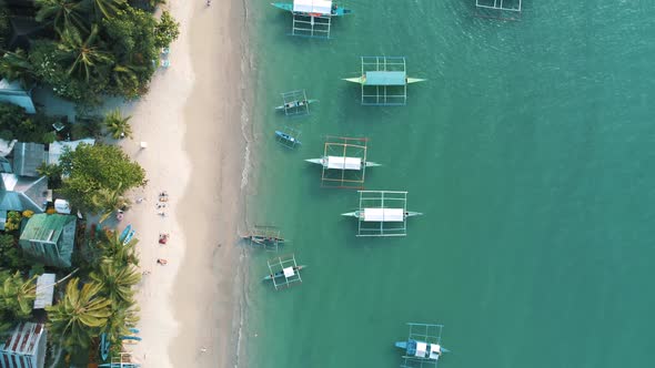 Top Drone View of a Traditional Philippine Boats on the Surface of the Azure Water in the Lagoon